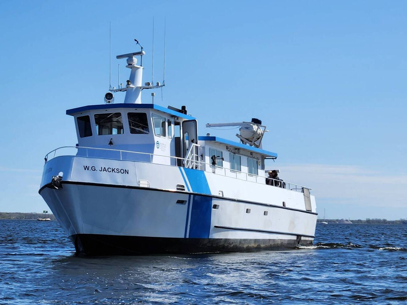 AWRI's second research vessel, the W.G. Jackson cruises on a lake.